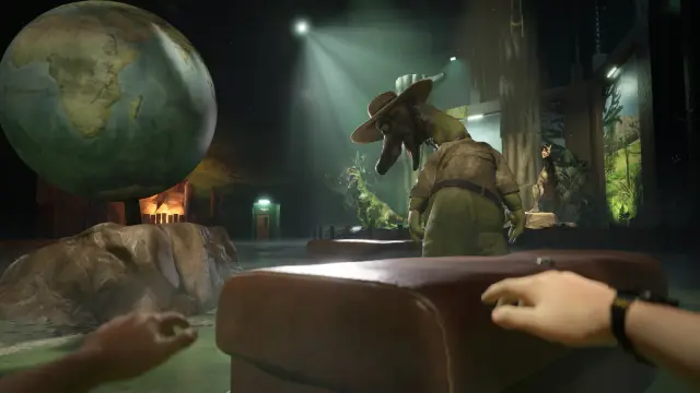 Large globe, exhibit scenery and a dinosaur-costumed figure in the Watering Hole
