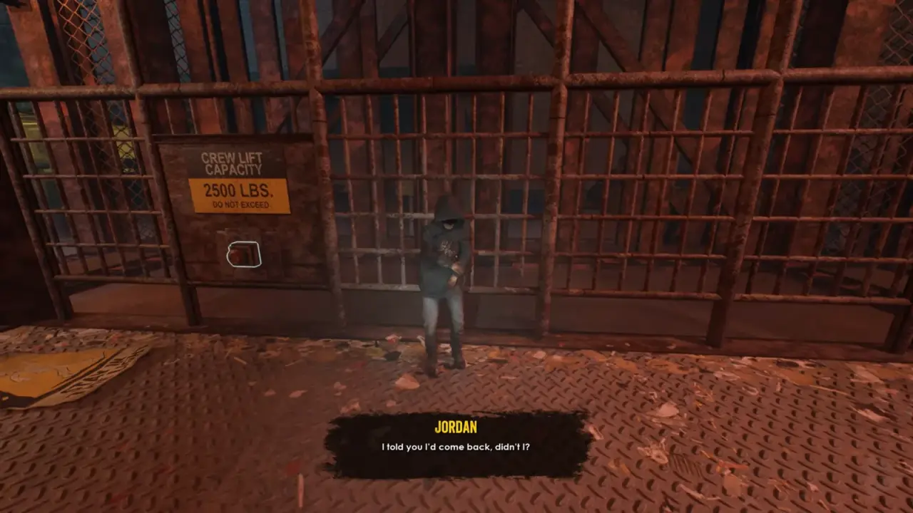 DJ stands in front of the barred Crew Lift gate beside its capacity sign.